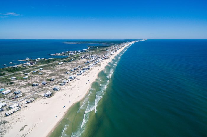 Drone/Aerial ocean photograph of the Gulf Shores/Fort Morgan peninsula. The warm Gulf of Mexico washes onto this pristine white sand beach. Alabama, USA