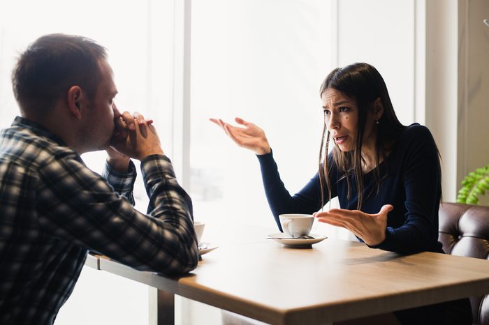 Young couple arguing in a cafe. Relationship problems.