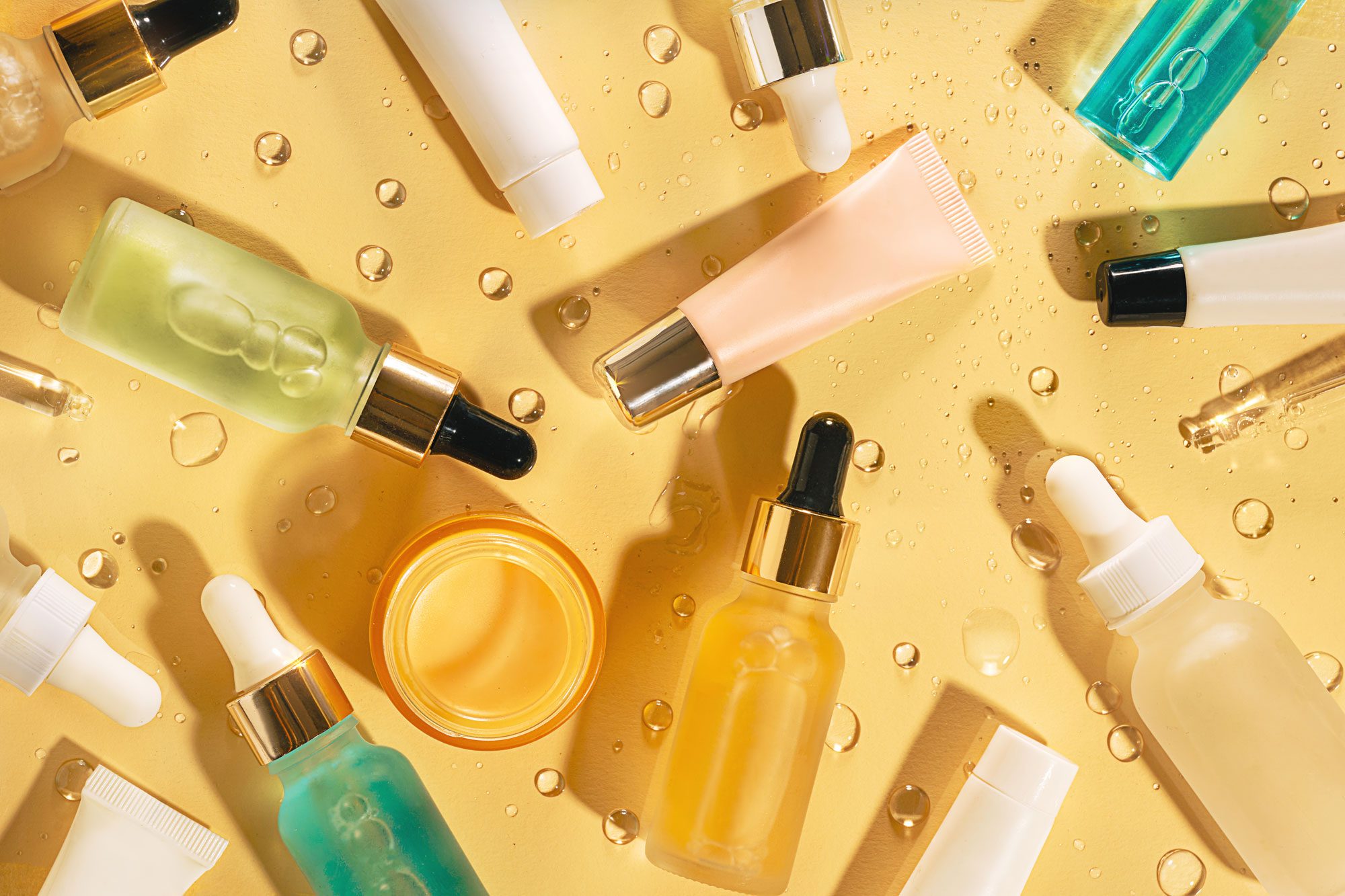 Glass Bottles With Natural Cosmetic Serum Cream And Gel With Drops Of Liquid