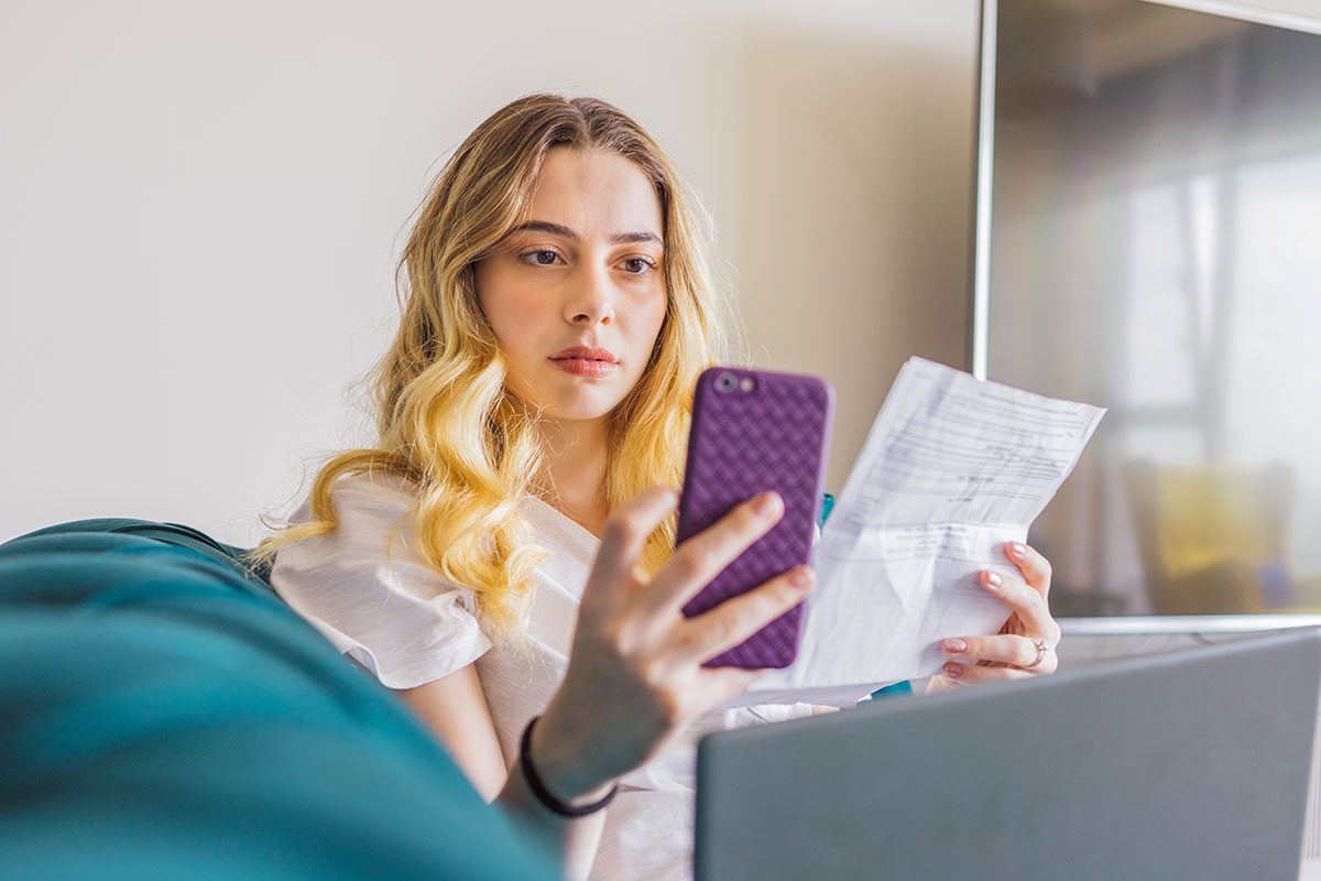 Woman who is surprised to see her bank account while paying her bill