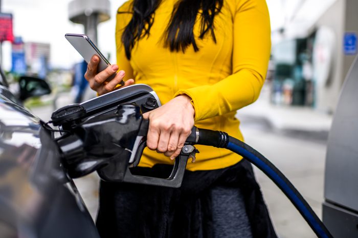Filling a car with gas at a station