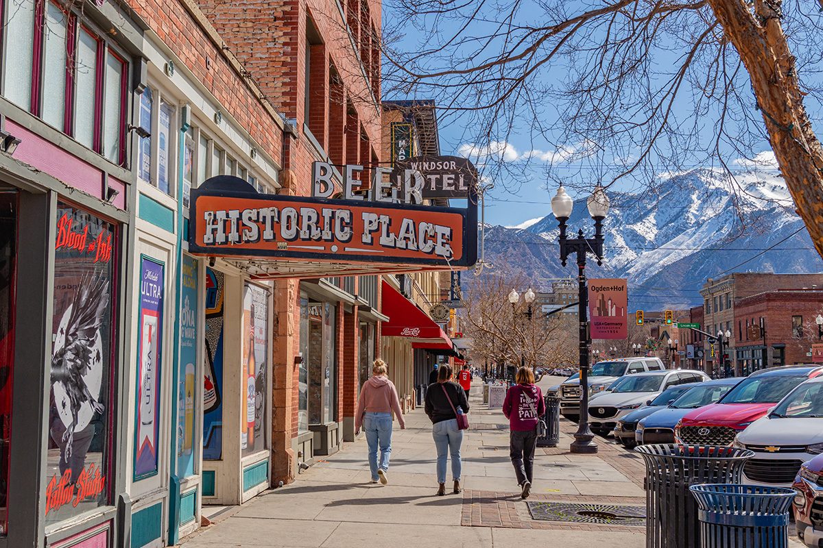 Historic downtown of this Utah city with quaint brick buildings and scenic snow-capped mountains in backgroun